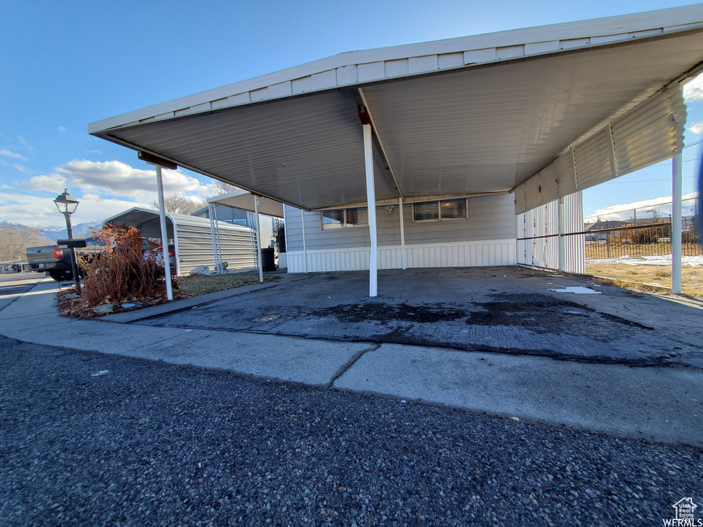 View of parking featuring a carport