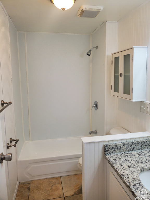 Full bathroom with vanity, tile patterned flooring,  shower combination, and toilet