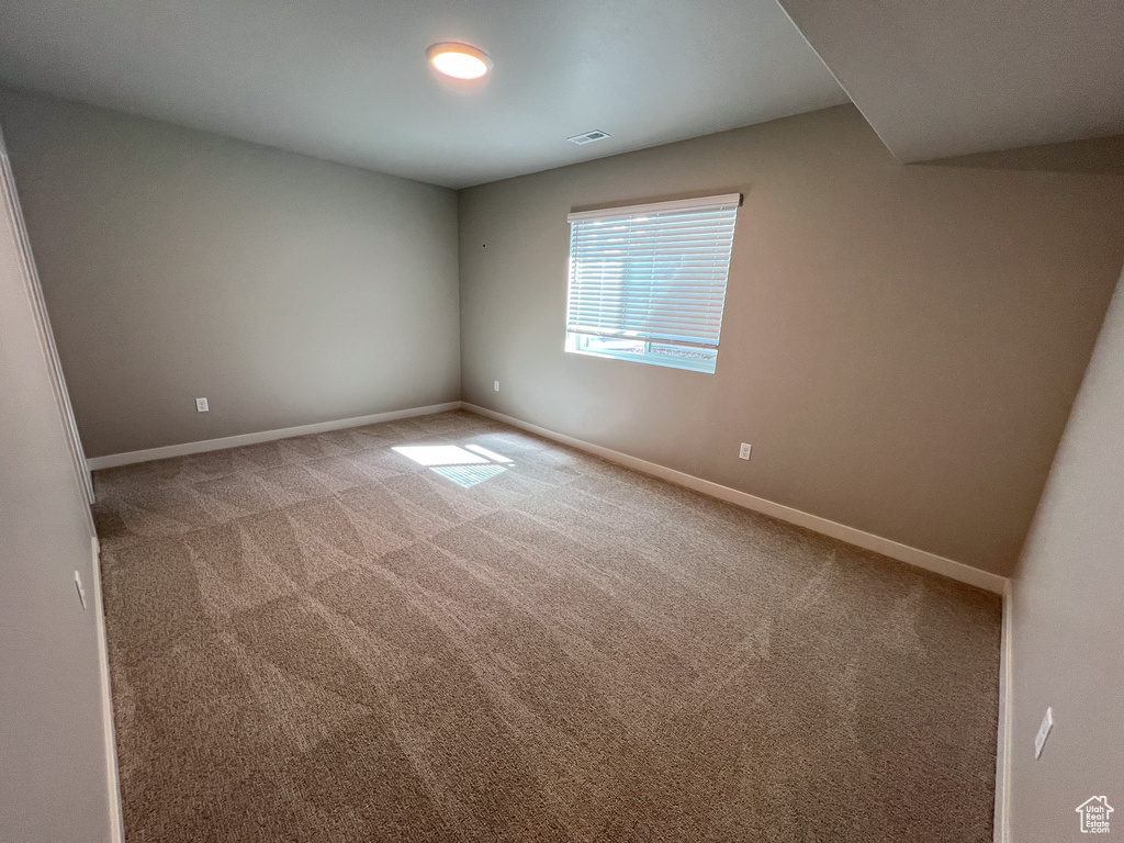 Spare room featuring carpet floors