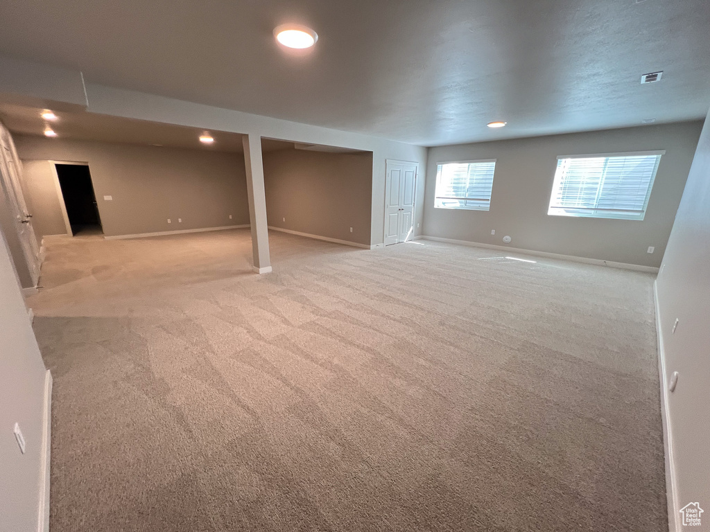 Basement with light colored carpet