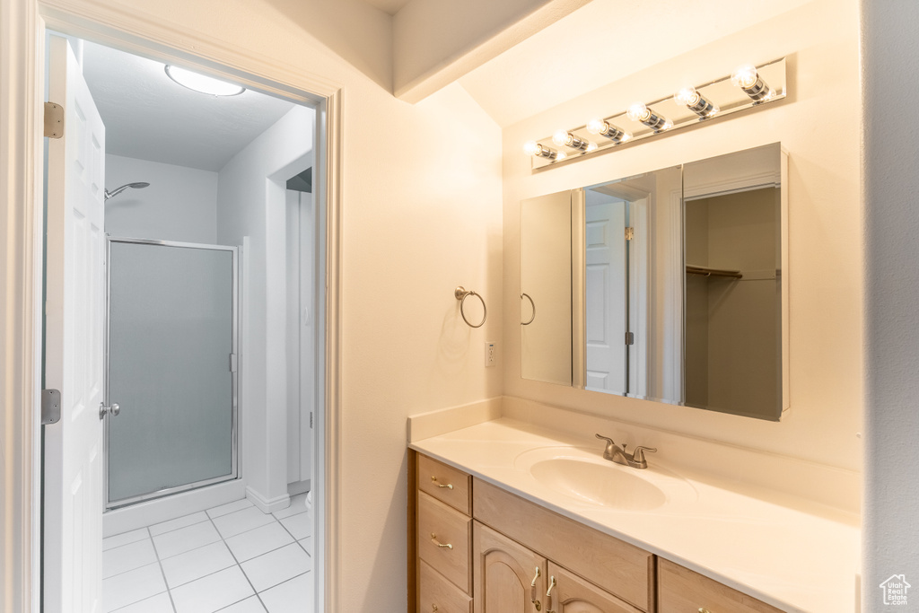 Bathroom featuring vanity, an enclosed shower, and tile patterned floors