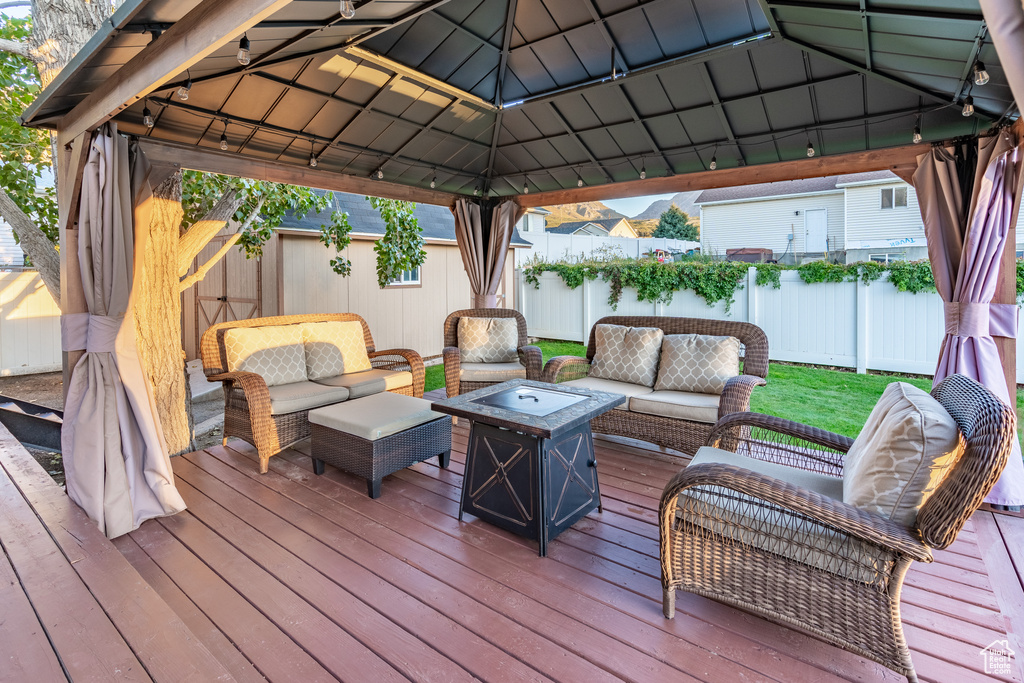 Wooden terrace with an outdoor living space and a gazebo