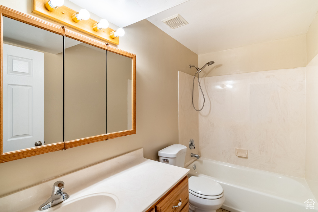 Full bathroom with vanity, shower / bathing tub combination, and toilet