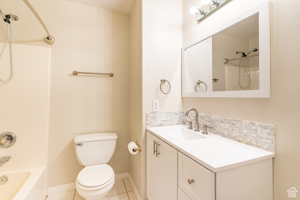 Full bathroom with shower / tub combination, tile patterned floors, vanity, and toilet