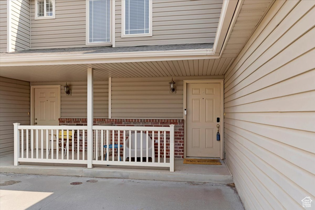 View of exterior entry featuring a porch