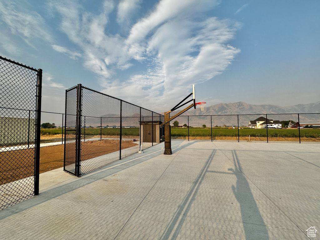 View of community with a mountain view and basketball hoop