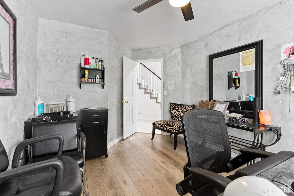 Home office featuring ceiling fan and light wood-type flooring