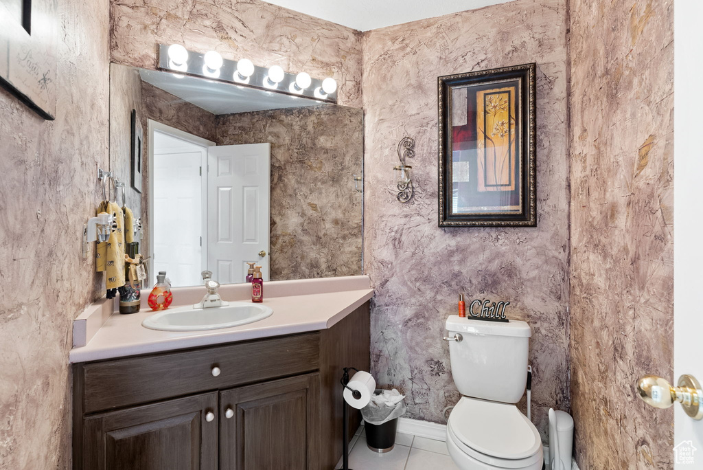 Bathroom with tile patterned floors, toilet, and vanity