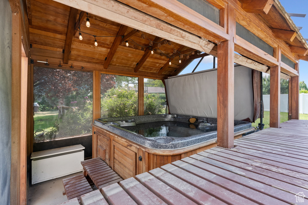 Exterior space featuring lofted ceiling with beams and wood ceiling