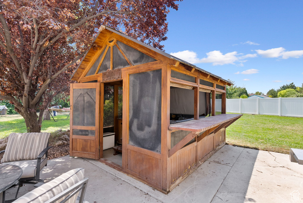 View of outbuilding featuring a lawn