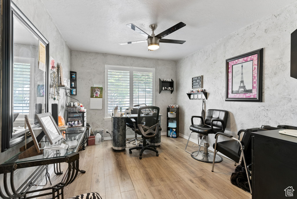 Office area with ceiling fan and light hardwood / wood-style flooring