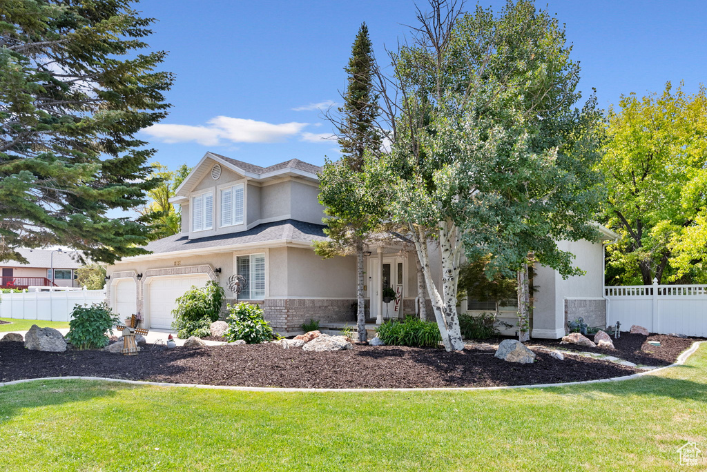 View of front facade with a garage and a front yard