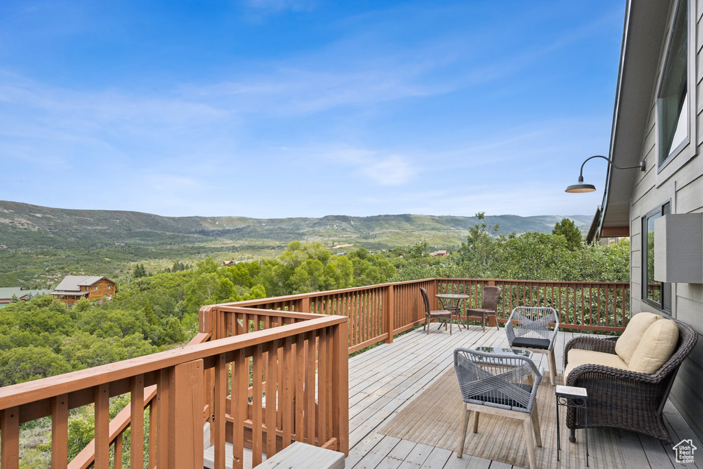 Wooden terrace featuring a mountain view