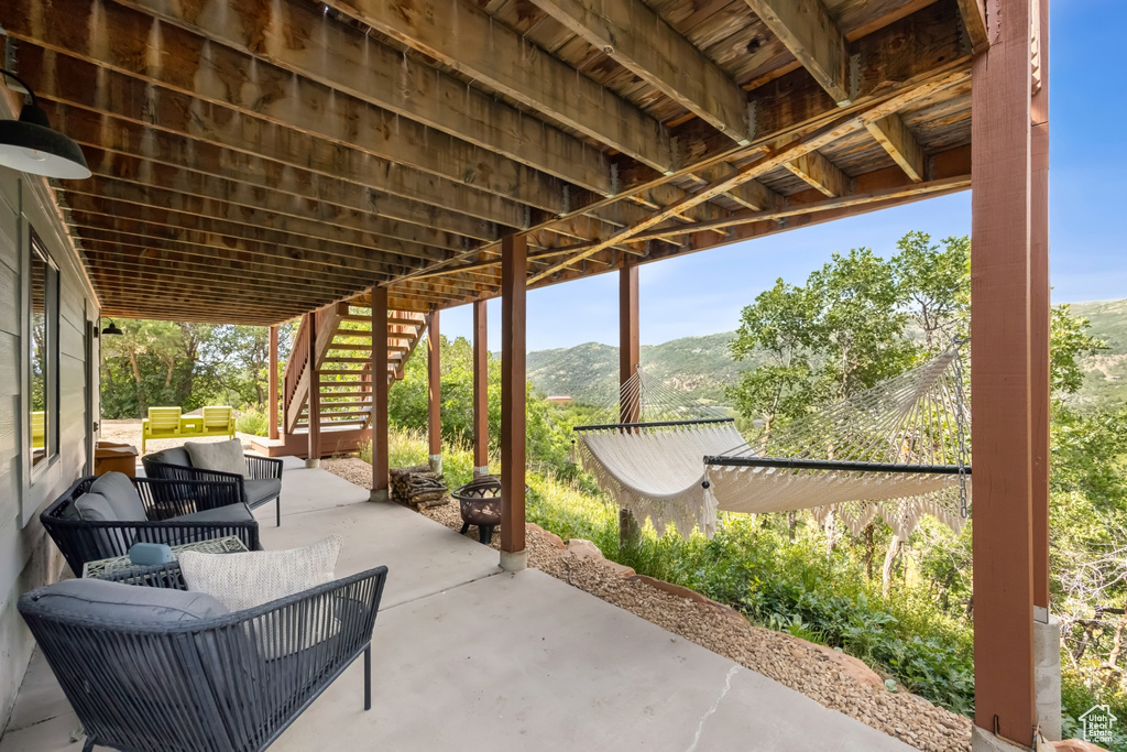 View of patio / terrace with a deck with mountain view and an outdoor living space