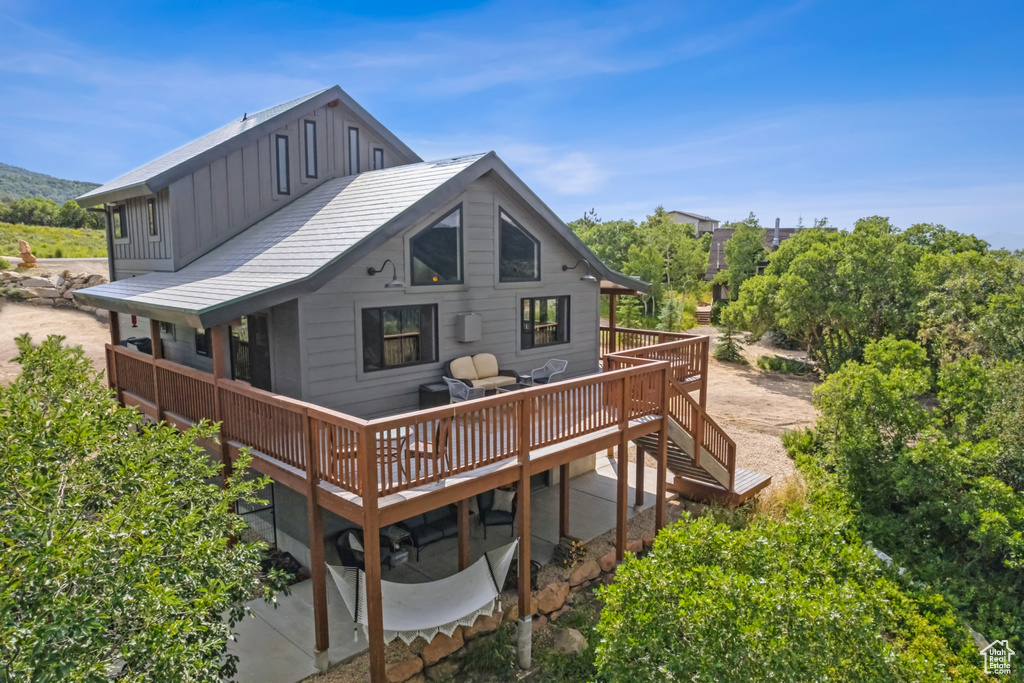 Back of house with a wooden deck