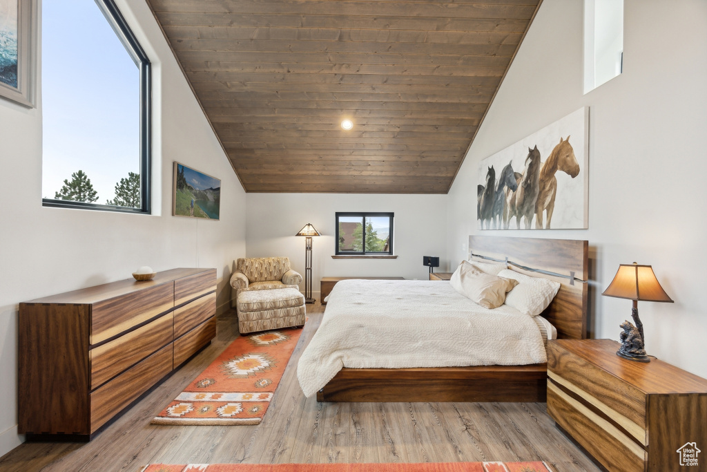 Bedroom with wood-type flooring, vaulted ceiling, and wood ceiling