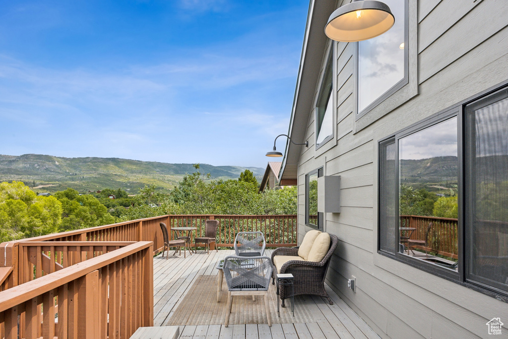 Wooden terrace with an outdoor living space and a mountain view