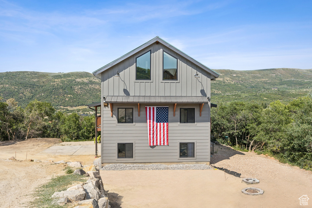 View of front of home featuring a mountain view and a patio