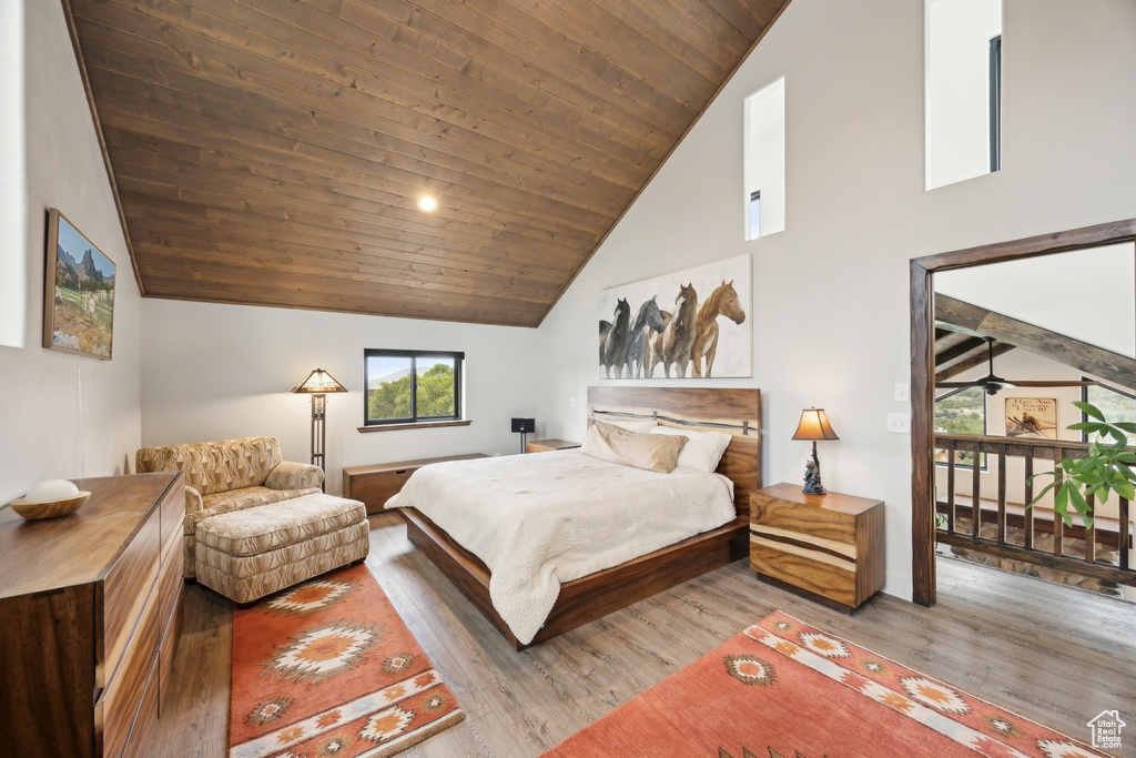 Bedroom featuring high vaulted ceiling, wooden ceiling, and wood-type flooring