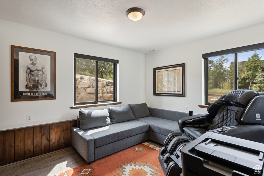 Living room with a wealth of natural light and hardwood / wood-style floors