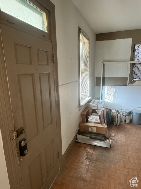 Foyer with plenty of natural light and parquet flooring