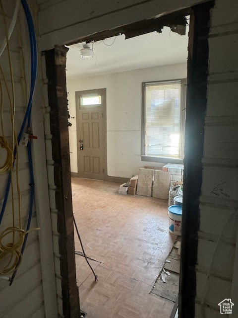 Interior space with a healthy amount of sunlight and parquet flooring