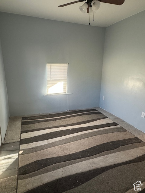 Empty room featuring ceiling fan