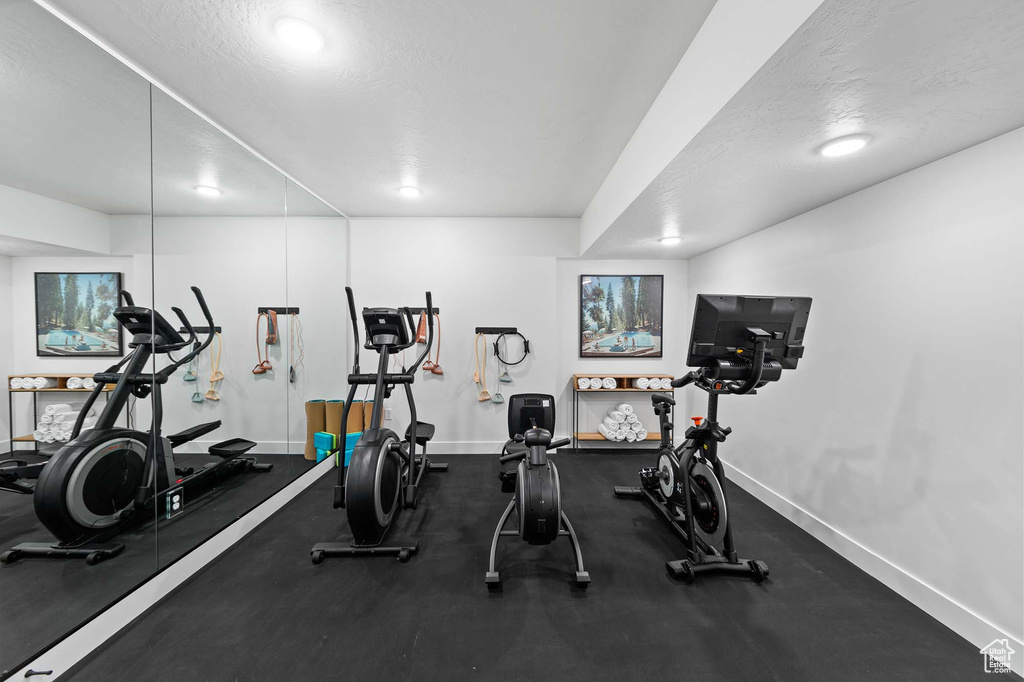 Exercise area featuring a textured ceiling