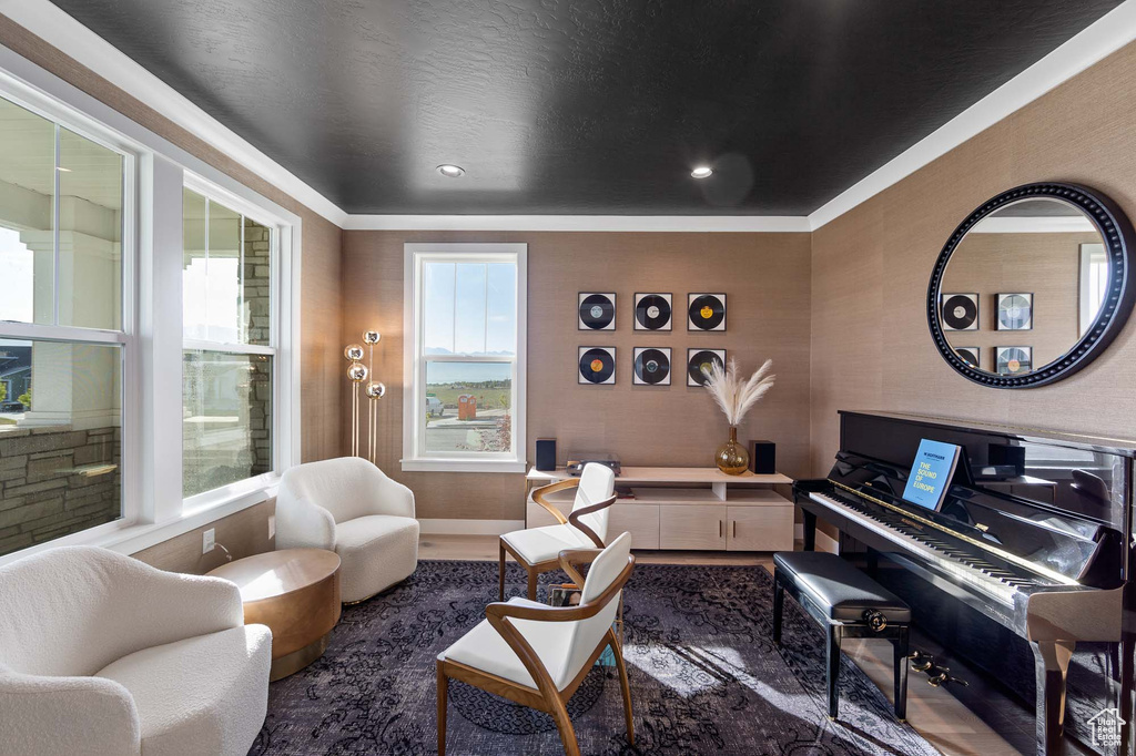 Living room featuring dark hardwood / wood-style floors, plenty of natural light, and crown molding