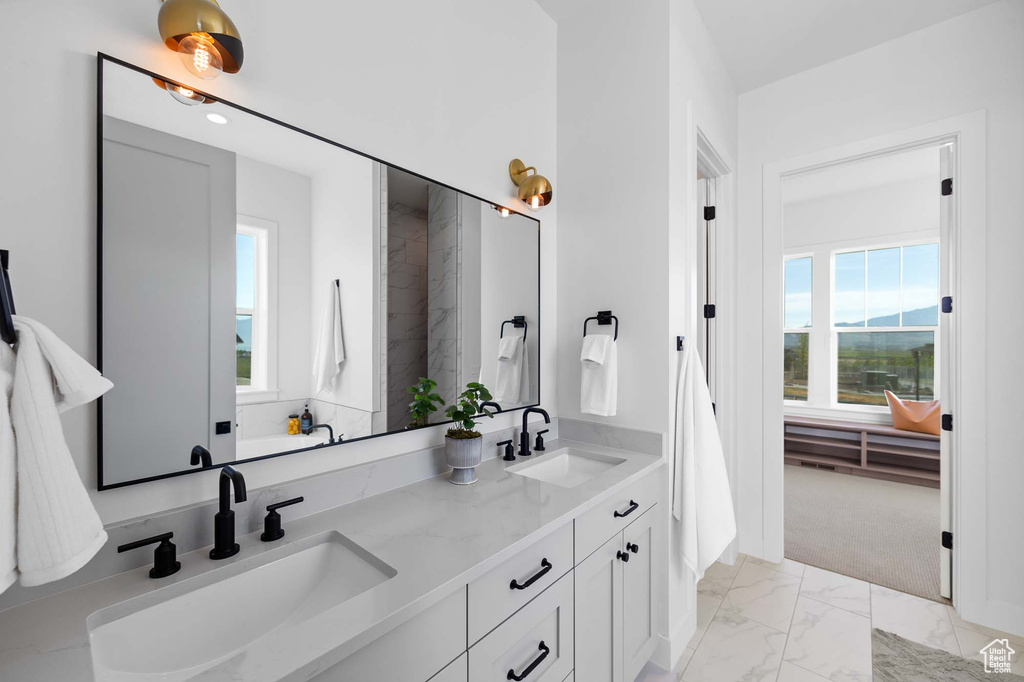 Bathroom featuring dual bowl vanity and tile floors