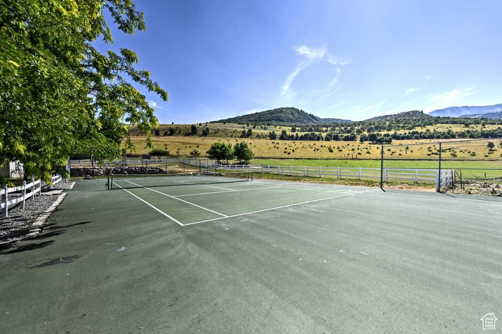 View of sport court with a mountain view and a rural view