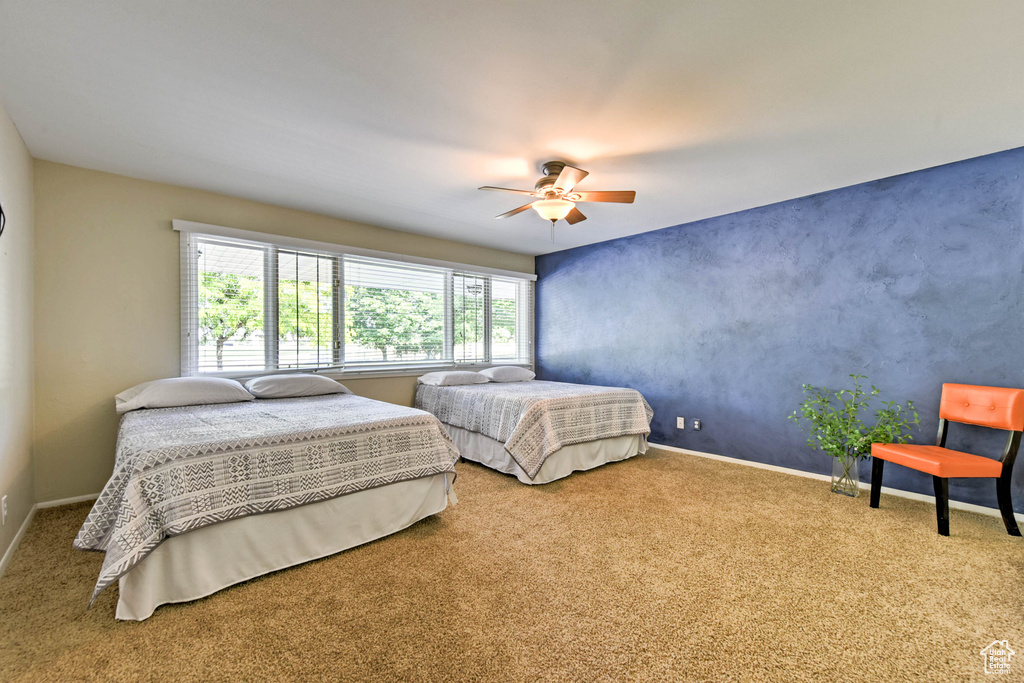 Carpeted bedroom with ceiling fan