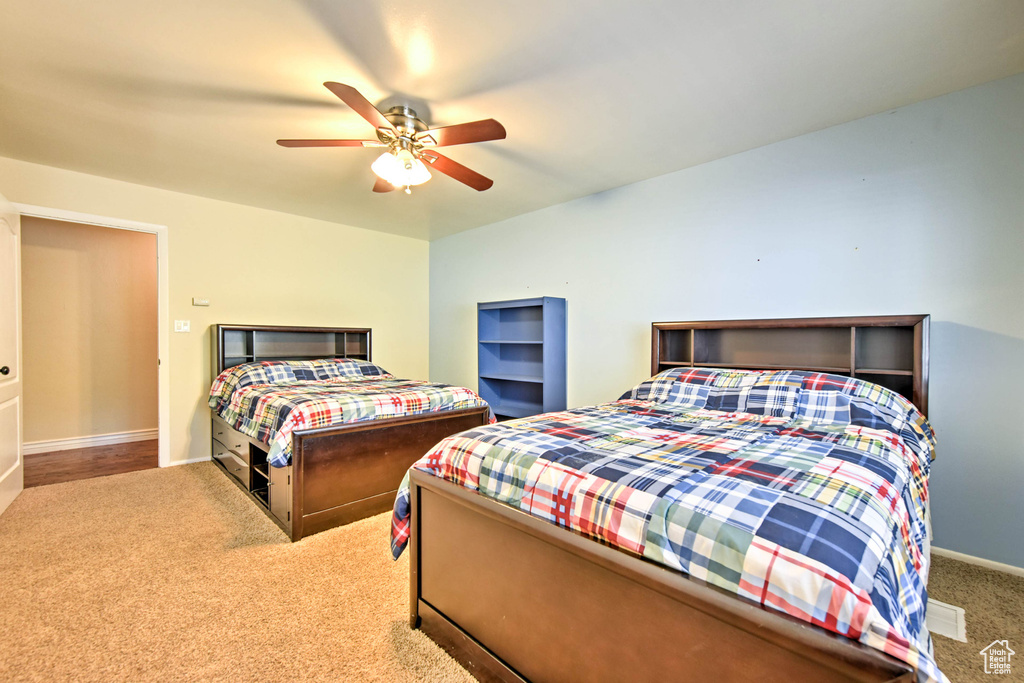 Carpeted bedroom with ceiling fan