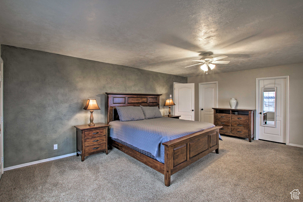 Bedroom featuring light colored carpet and ceiling fan