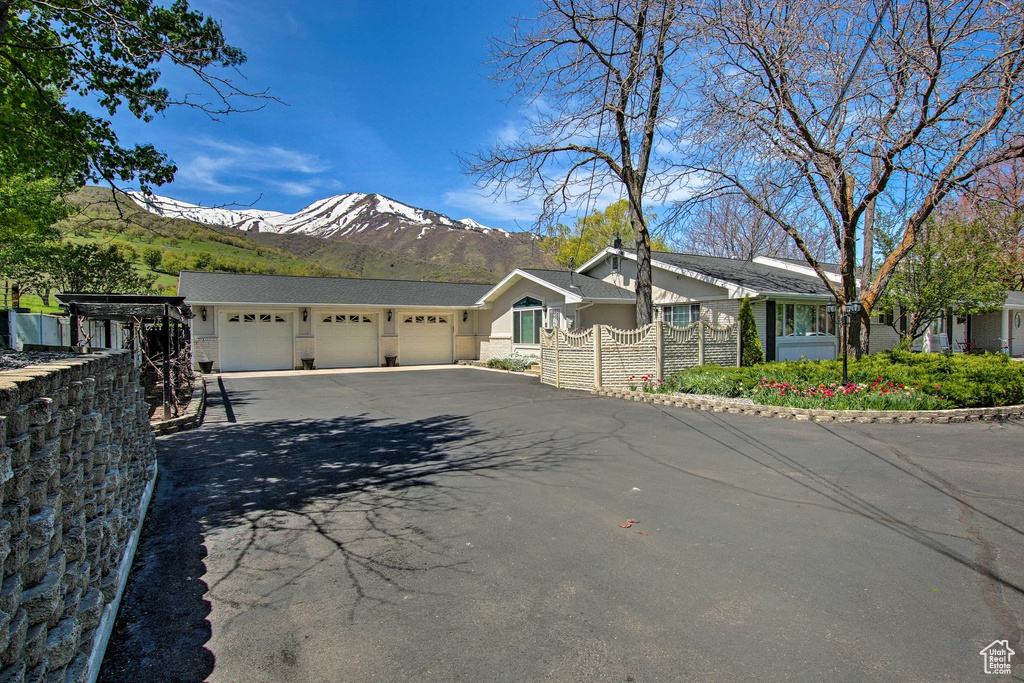 Single story home featuring a mountain view and a garage