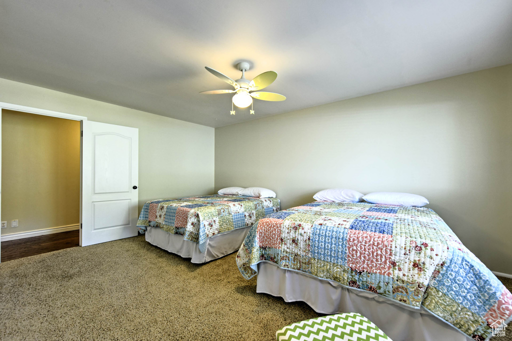 Bedroom with ceiling fan and hardwood / wood-style floors