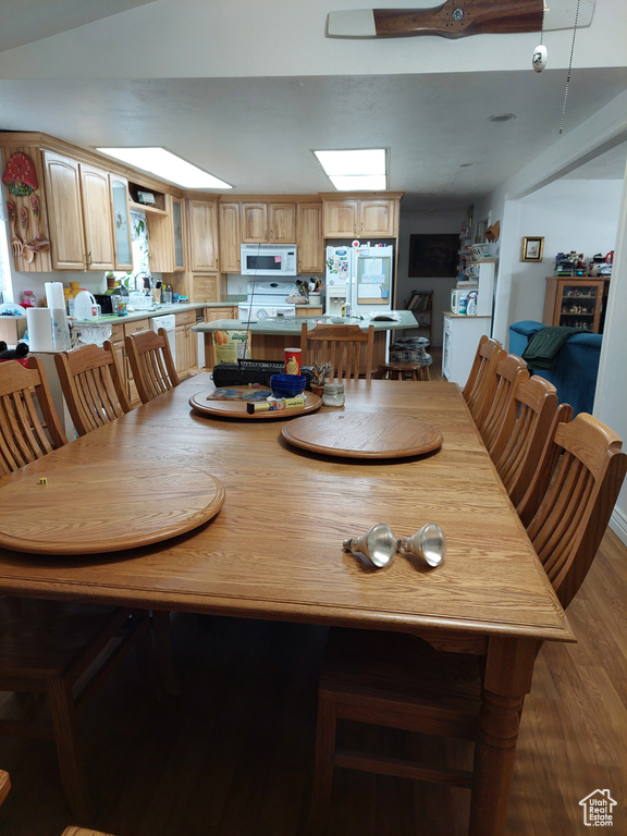 Dining room featuring a skylight and hardwood / wood-style floors