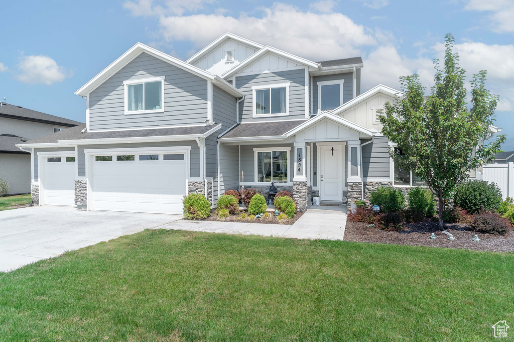 Craftsman-style home with a garage and a front yard