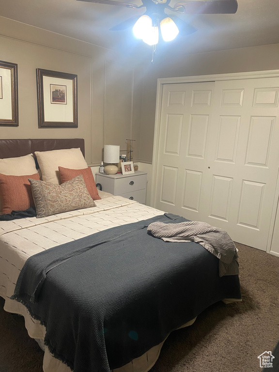 Bedroom featuring carpet, ceiling fan, and a closet