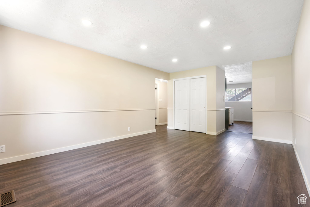 Unfurnished room featuring dark hardwood / wood-style floors