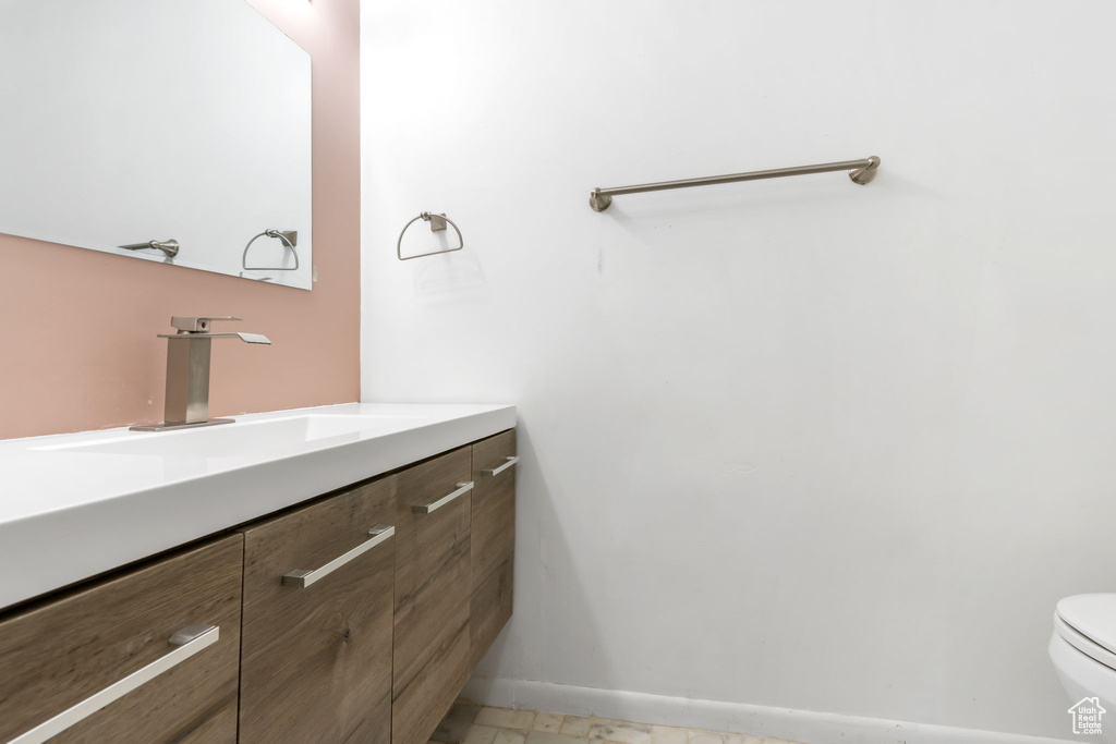 Bathroom with vanity, tile patterned flooring, and toilet