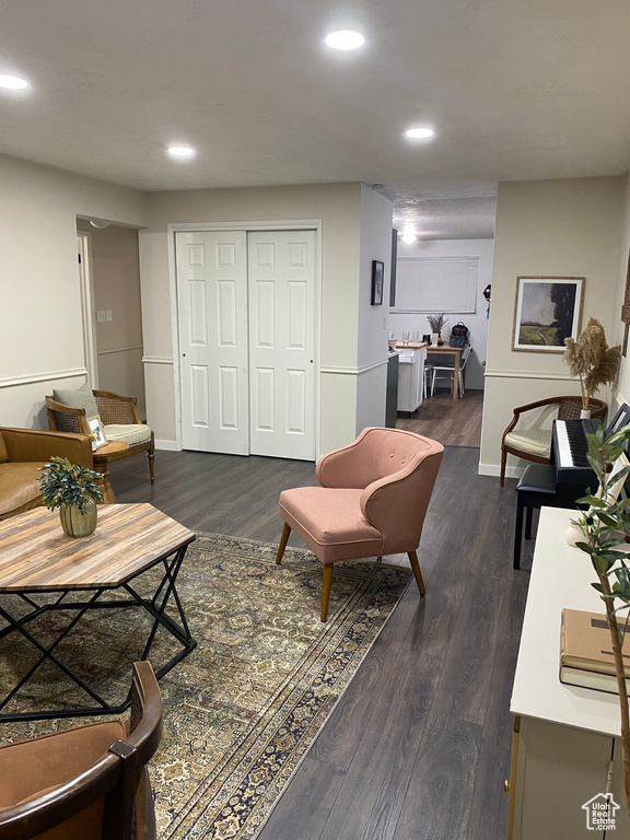 Living room with dark hardwood / wood-style flooring