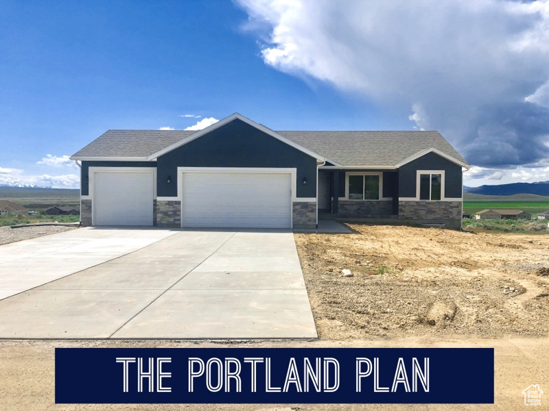 View of front facade featuring a garage