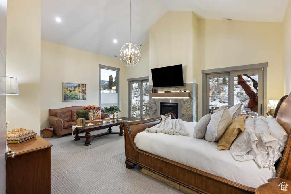 Bedroom featuring a chandelier, multiple windows, high vaulted ceiling, and carpet