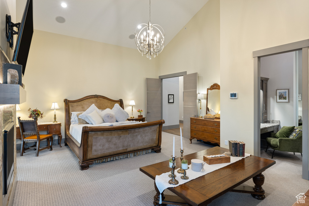 Bedroom featuring high vaulted ceiling, carpet flooring, and an inviting chandelier