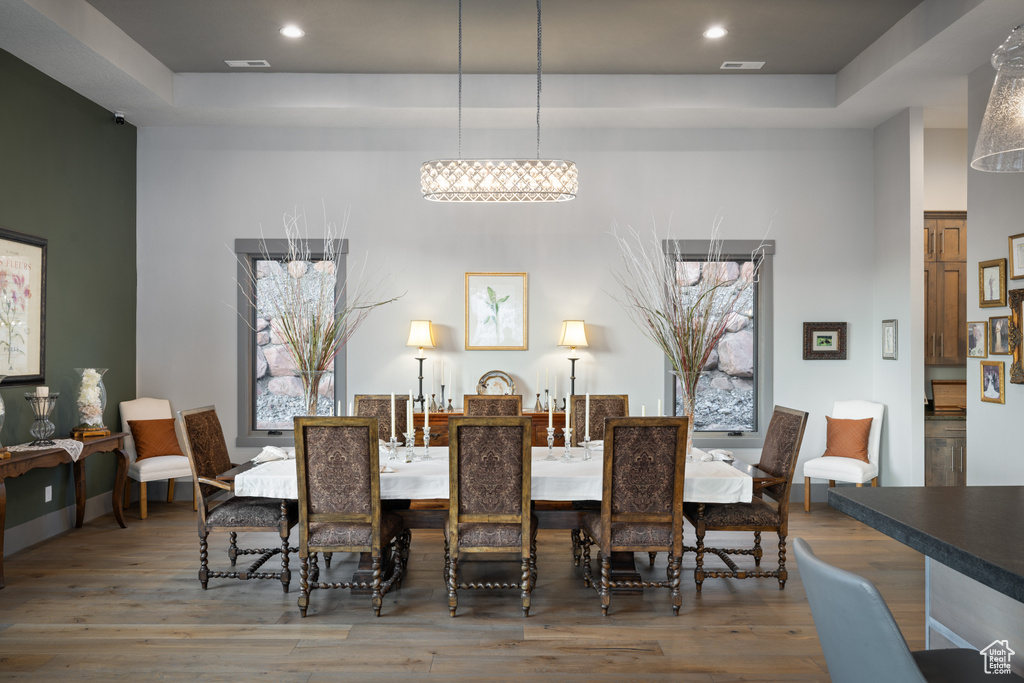 Dining area with visible vents, recessed lighting, and wood finished floors