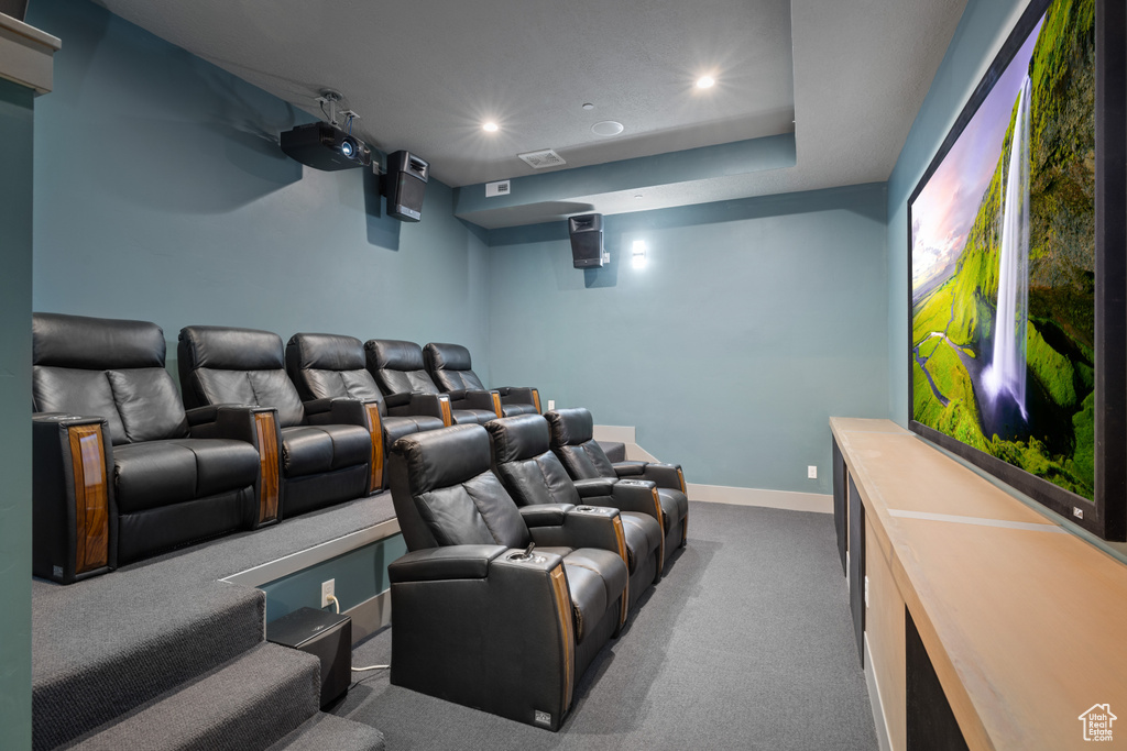 Carpeted cinema room with recessed lighting and baseboards
