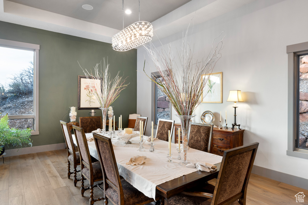 Dining room with plenty of natural light, light wood-style floors, and baseboards