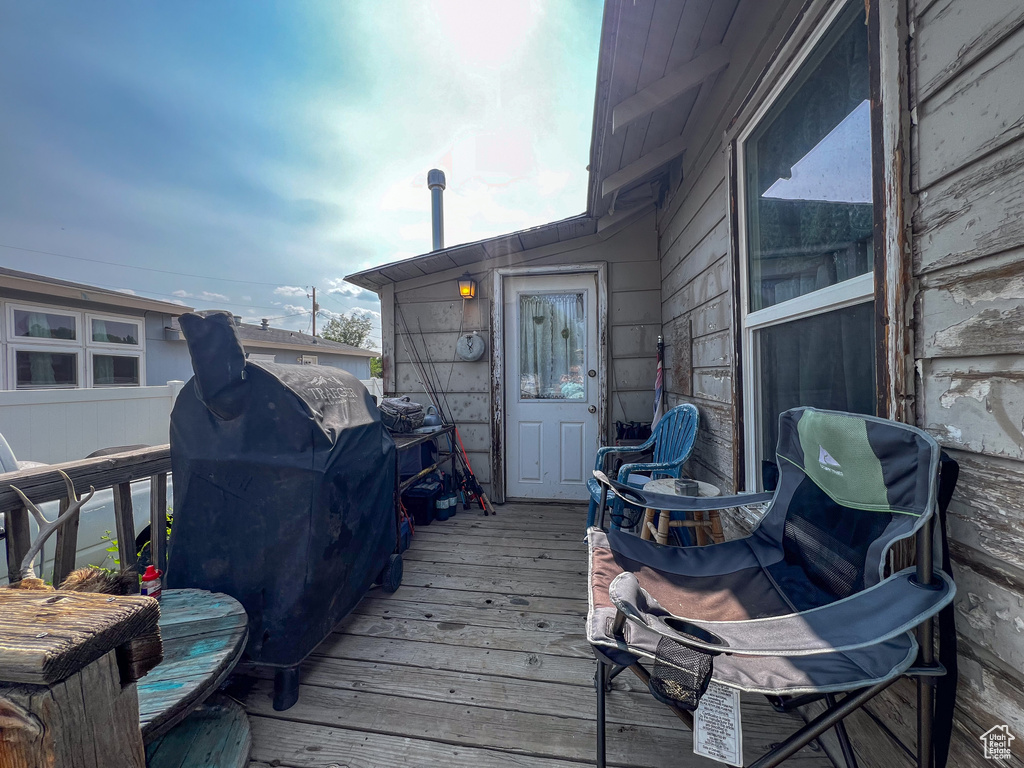 Wooden deck featuring area for grilling