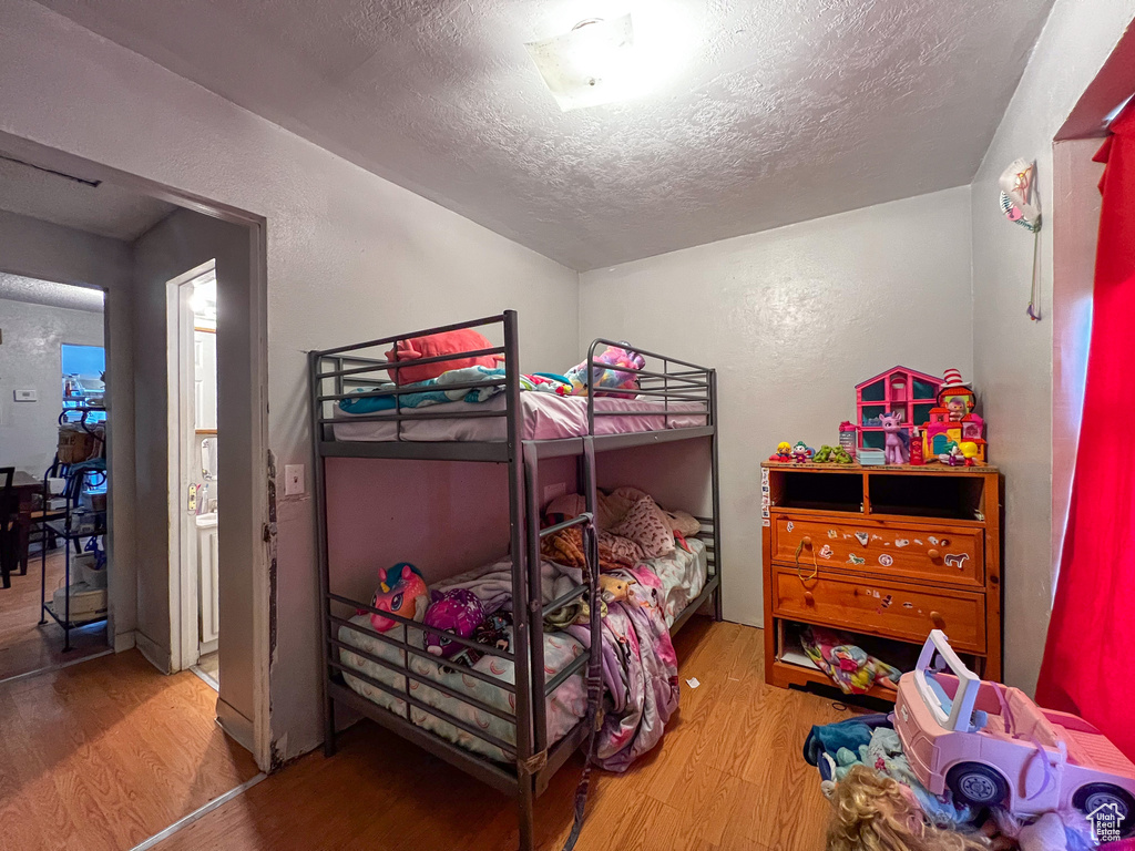 Bedroom featuring light wood-type flooring and a textured ceiling